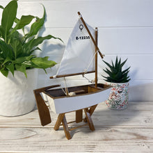 Load image into Gallery viewer, Decorative wooden model sailboat Optimist | 30cm (w) x 45cm (h) x 13.5cm (d) | Fully assembled model |Hand-painted and handmade from wood.