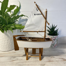 Load image into Gallery viewer, Decorative wooden model sailboat Optimist | 30cm (w) x 45cm (h) x 13.5cm (d) | Fully assembled model |Hand-painted and handmade from wood.
