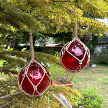 Load image into Gallery viewer, TWO DEEP RED GLASS FISHING FLOAT ORNAMENTAL SEA BUOY | hand blown | nautical seafaring fishing rustic décor | 10cm diameter | with rustic brown string netting and hanging loop | Japanese style glass fishing floats