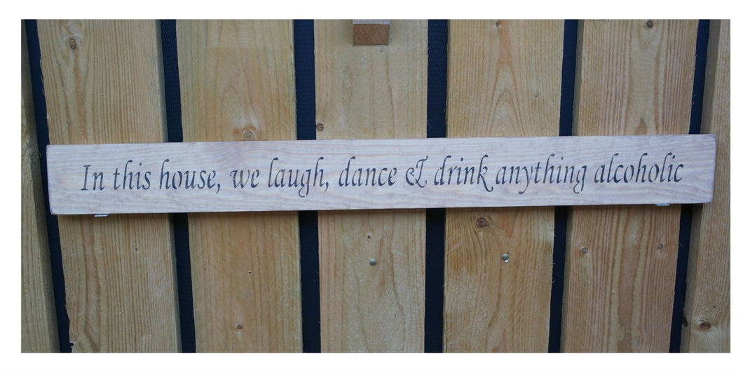 British handmade wooden sign In this house, We laugh, dance and drink anything alcoholic