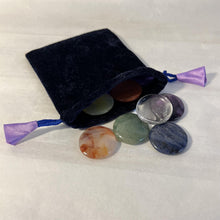 Load image into Gallery viewer, Set of 7 Chakra Discs supplied with a Velvet Bag | Discs include Clear Quartz, Amethyst, Sodalite, Green Aventurine, Yellow Onyx, Carnelian, and Red Jasper.
