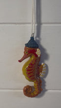 Load and play video in Gallery viewer, Ceramic cute bobble hat Seahorse hanging ornament | Light Pull | Nautical Theme ceramic Cord Pull Light Pulls