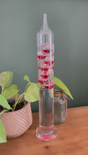 Load and play video in Gallery viewer, 30cm Tall Free Standing Galileo Thermometer with seven red floating globes | measures temperatures from 16 degrees Centigrade to 28 degrees | also in Fahrenheit | Weather station | Water Thermometer