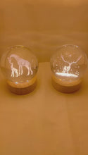 Load and play video in Gallery viewer, Set of Two 3D Crystal Ball Night Light USB Lamp with Reindeer and Giraffe designs, elegant modern illumination for any room