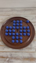 Load and play video in Gallery viewer, 30cm Diameter DARK WOOD SOLITAIRE BOARD GAME with OPAL BLUE Glass Marbles | |classic wooden solitaire game | strategy board game | family board game | games for one | board games