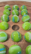 Load and play video in Gallery viewer, 22cm Diameter wooden SOLITAIRE BOARD GAME with GREEN LEPRECHAUN GLASS MARBLES | classic wooden solitaire game | strategy board game | family board game | games for one | board games
