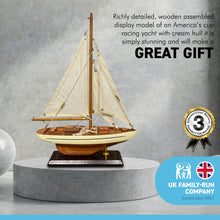 Load image into Gallery viewer, Detailed wooden assembled display model of an Americas Cup Racing Yacht with cream hull | ready for display | adjustable rigging blocks sewn cotton sails | length 25cm height 35cm