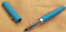 Load image into Gallery viewer, J Herbin Blue metal roller ball pen with fine nib and tin of 6 Blue Bleu Myosotist cartridges
