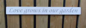 British handmade wooden sign Love grows in the garden