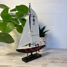 Load image into Gallery viewer, Americas Cup Model Yacht  - Black and Red hull | Sailing | Yacht | Boats | Models | Sailing Nautical Gift | Sailing Ornaments | Yacht on Stand | 23cm (H) x 16cm (L) x 3cm (W)
