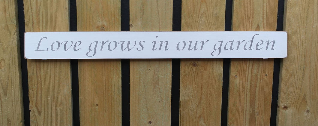 British handmade wooden sign Love grows in the garden
