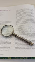 Load and play video in Gallery viewer, Vintage Silver Handheld Magnifier with geometric patterned handle, perfect for reading, crafting and precision work
