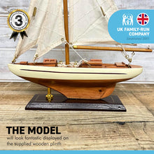 Load image into Gallery viewer, Detailed wooden assembled display model of an Americas Cup Racing Yacht with cream hull | ready for display | adjustable rigging blocks sewn cotton sails | length 25cm height 35cm
